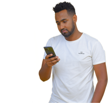 WubSites graphic designer using a phone to create eye-catching marketing materials for an Ethiopian import/export business.